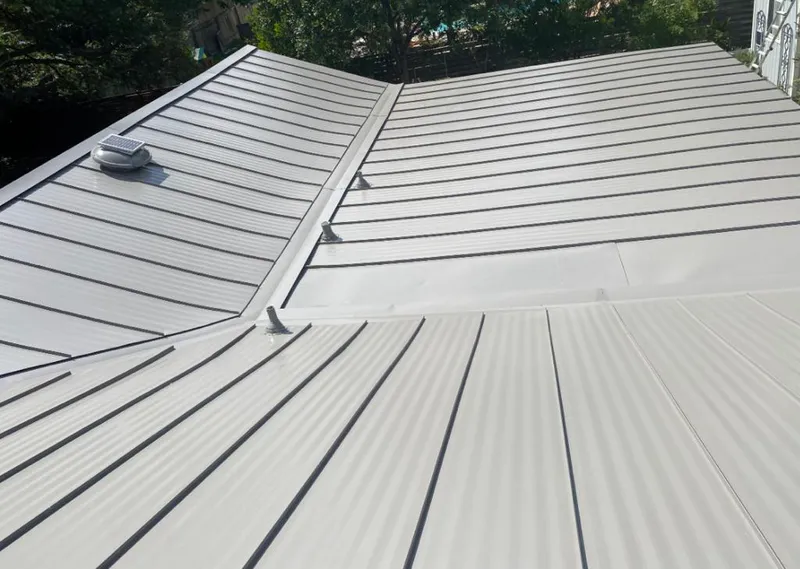 Solar attic fan installed on a metal roof for Roof Ventilation in Baraboo